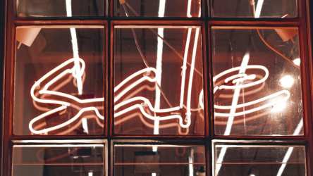 Sale sign in window (neon) - Photo by Alexandre Debiève on Unsplash
